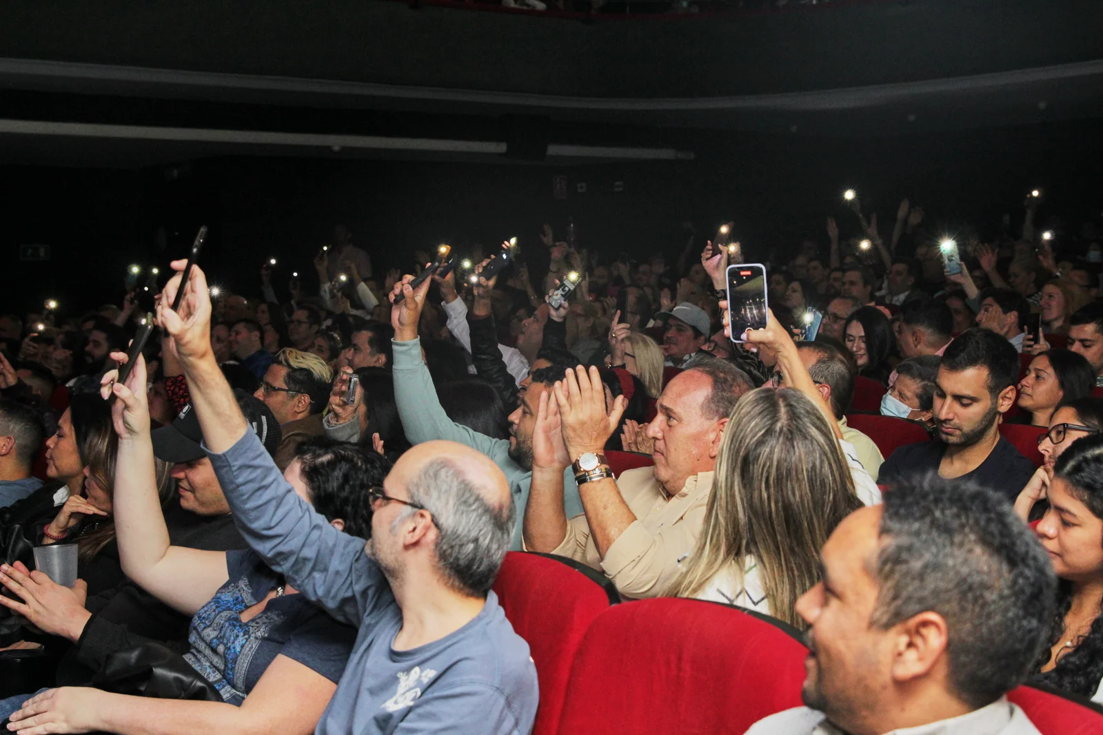 Audience holding up phones at a live show