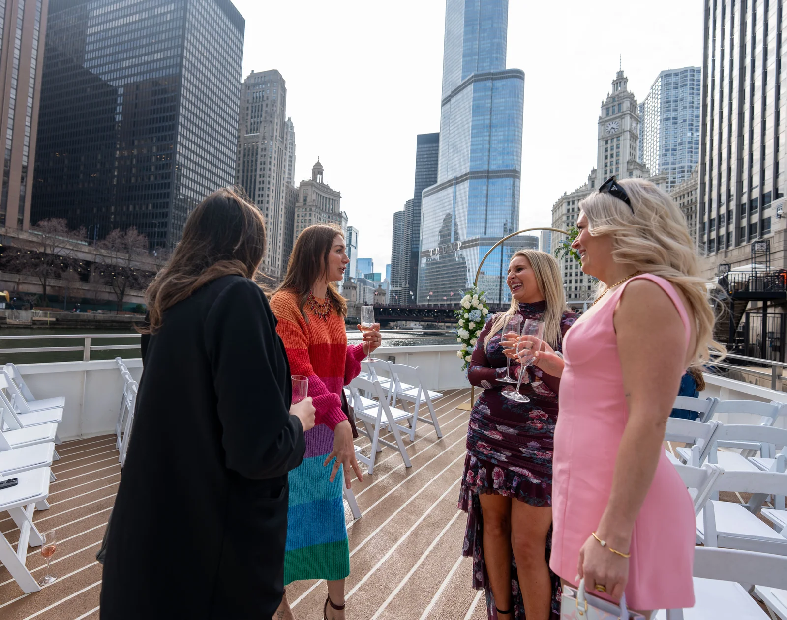 Guests on a boat deck with the skyline behind