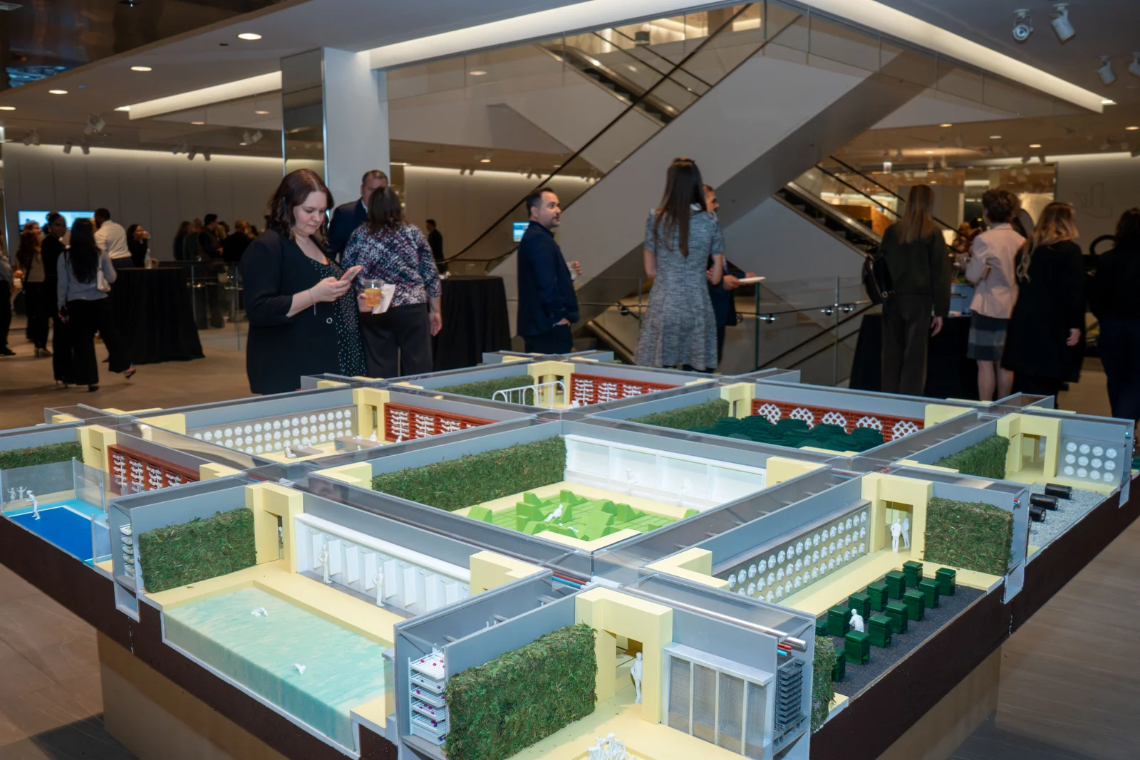 Guests around an architectural model at a Magnificent Mile Association reception
